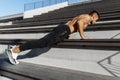 Young sporty shirtless man doing push-ups outdoors, focused athlete doing exercises outdoors, sport, motivation Royalty Free Stock Photo