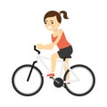 Sporty smiling girl in sportswear riding on bike