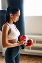 Sporty tiired woman wearing boxing gloves posing in gym Royalty Free Stock Photo