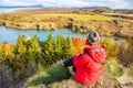 Sporty woman admires the lake Myvatn in Northern Iceland. Quiet autumn landscape