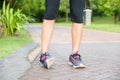 Sporty woman ankle sprain while jogging or running at park. Royalty Free Stock Photo