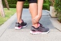 Sporty woman ankle sprain while jogging or running at park. Royalty Free Stock Photo