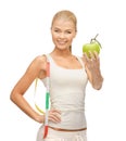 Sporty woman with apple and measuring tape Royalty Free Stock Photo