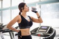 Sporty woman asia drinking water after exercises in the gym. Fitness - concept of healthy Royalty Free Stock Photo