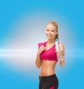 Sporty woman with bottle of water and towel Royalty Free Stock Photo