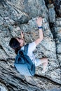 Sporty woman climbing on the cliff. Success and goal concept. Strong women power and healthy Royalty Free Stock Photo