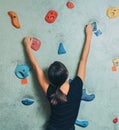Sporty woman climbing up on rock wall indoor Royalty Free Stock Photo