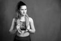 Sporty woman does the exercises. Photo of young woman in sportswear on dark background