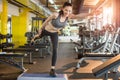 Sporty woman doing balance exercise on one leg on fitness stepper at gym Royalty Free Stock Photo