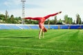 Sporty woman doing cartwheel on stadium Royalty Free Stock Photo