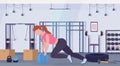 Sporty woman doing crossfit exercises with medicine leather ball girl training cardio workout concept modern gym health