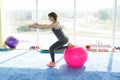 Sporty woman doing exercises with fit ball in gym. Concept: lifestyle, fitness, aerobics and health Royalty Free Stock Photo