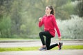 Sporty woman doing lunge exercises before running Royalty Free Stock Photo