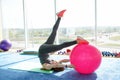 Sporty woman doing press exercises with fit ball in gym. Concept: lifestyle, fitness, aerobics and health Royalty Free Stock Photo