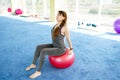 Sporty woman doing press exercises with fit ball in gym. Concept: lifestyle, fitness, aerobics and health Royalty Free Stock Photo