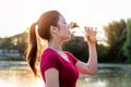 Sporty woman drinking water on sunlight Royalty Free Stock Photo