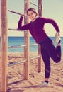 Sporty woman exercising at sea beach Royalty Free Stock Photo