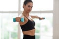 Sporty Woman Exercising With Two Dumbbells And Posing Royalty Free Stock Photo