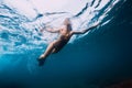 Sporty woman with fins swim in blue ocean Royalty Free Stock Photo