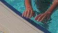 Close up of sporty woman getting out of a swimming pool