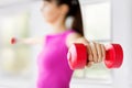 Sporty woman hands with light red dumbbells Royalty Free Stock Photo