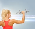 Sporty woman with heavy steel dumbbell from back