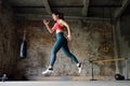 Sporty woman during HIIT workout. Sportswoman jumping high in the process of training in the gym