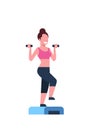 Sporty woman holding dumbbells doing squats on step platform girl training in gym aerobic workout healthy lifestyle