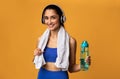 Sporty woman holding water bottle wearing headset at studio Royalty Free Stock Photo