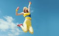 Sporty woman jumping with dumbbells. Funny woman in sportswear on sky background. Dynamic movement. Sport and healthy Royalty Free Stock Photo