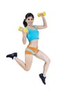 Sporty woman jumping with dumbbells Royalty Free Stock Photo