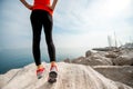 Sporty woman legs on the rocky beach Royalty Free Stock Photo