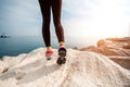 Sporty woman legs on the rocky beach Royalty Free Stock Photo