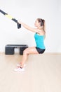 Sporty woman makes suspension training