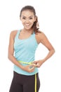 Sporty woman measures her waist with measuring tape Royalty Free Stock Photo