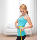 Sporty woman with measuring tape Royalty Free Stock Photo