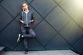 Sporty woman with perfect figure and buttocks stretching her arms against wall with copy space for your text message, fit female i Royalty Free Stock Photo