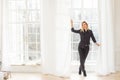 sporty woman posing in fancy hall in front of windows with curtains toned image Royalty Free Stock Photo