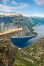 Sporty woman posing on Trolltunga Norway