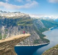 Sporty woman posing on Trolltunga Norway