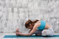 Sporty woman practicing yoga indoors on blue mat Royalty Free Stock Photo