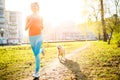 Sporty woman runing with dog