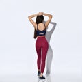 Attractive girl in modern fashionable dark red cherry sportswear make dynamic movement