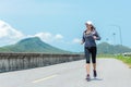 Sporty Woman runner running through the road. Royalty Free Stock Photo