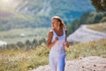 Sporty woman running along forest trail. Mountains landscape. Sports workout. Morning running outdoors. Sport, fitness. Royalty Free Stock Photo