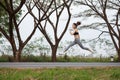 Sporty woman running and jumping in park Royalty Free Stock Photo