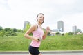 Sporty woman running outdoors in park Royalty Free Stock Photo