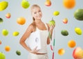 Sporty woman with scale, apple and measuring tape Royalty Free Stock Photo