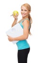 Sporty woman with scale and green apple Royalty Free Stock Photo