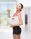 Sporty woman with scale and green apple Royalty Free Stock Photo